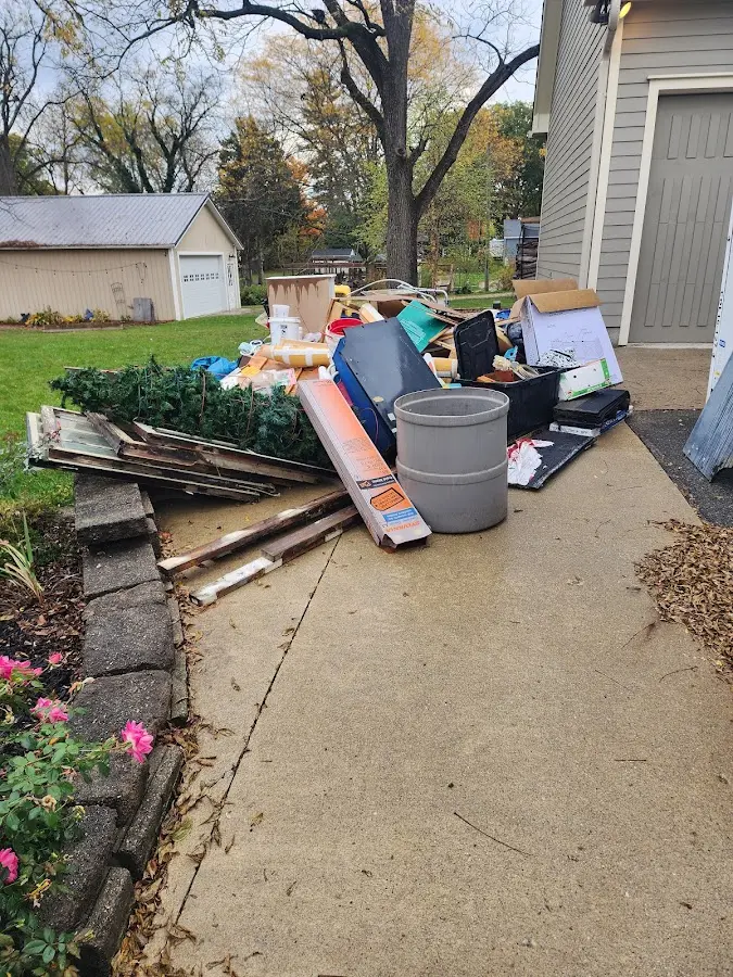 Dumpster being loaded with debris for 12 Yard Dumpster Rental in Putnam